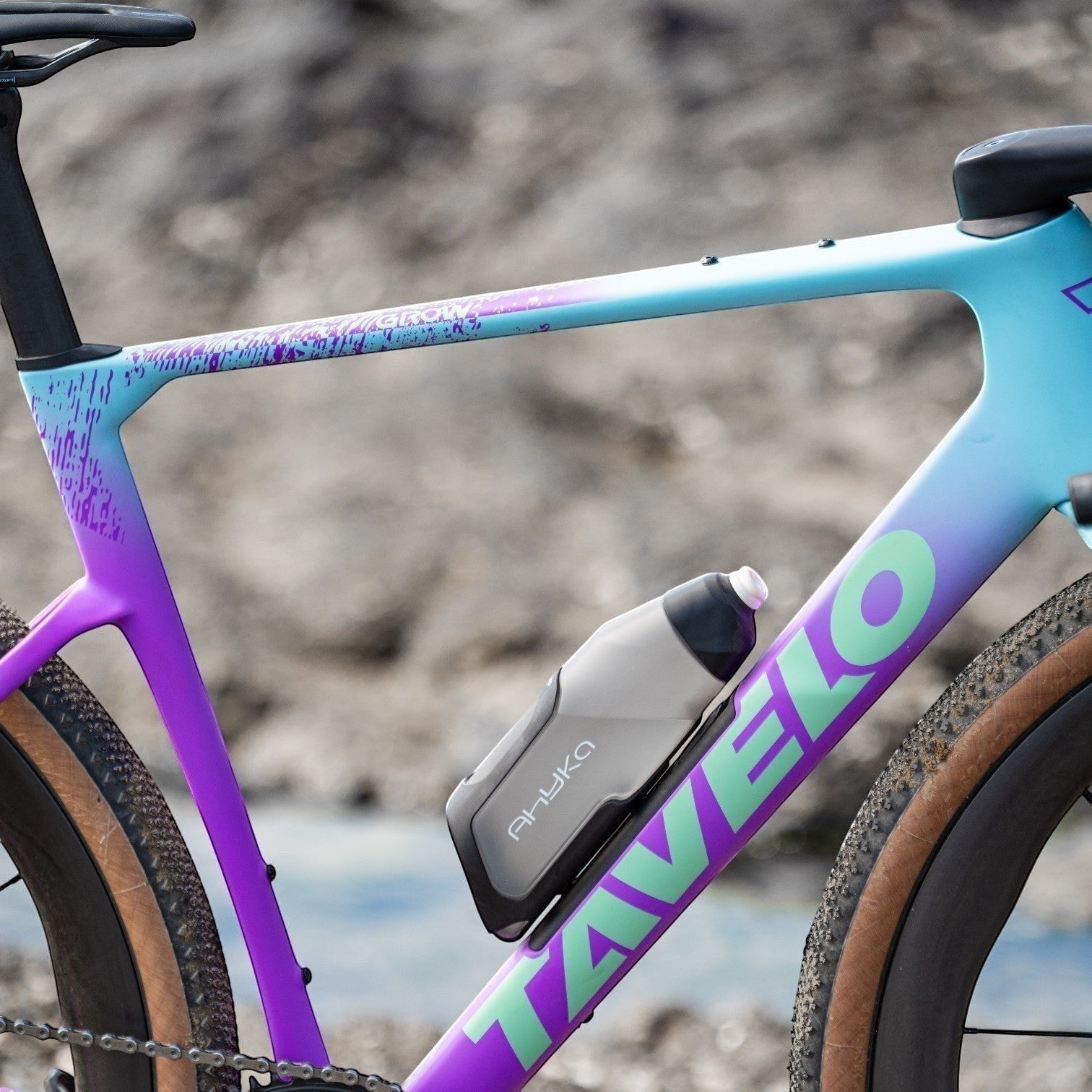 NorVelo Tavelo Grow aero gravel bike frame in a vibrant blue to purple gradient finish with integrated FIDLOCK bottle