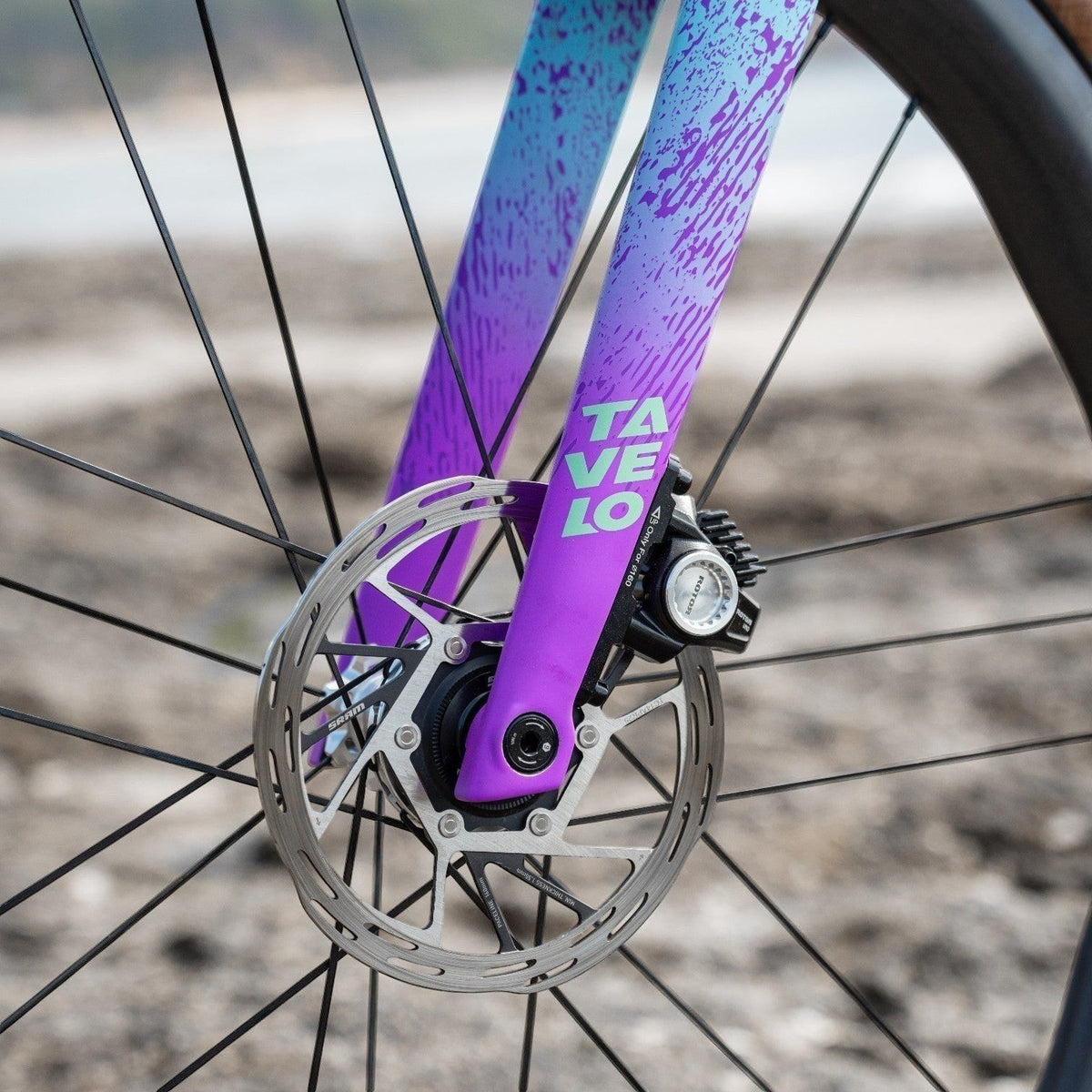 NorVelo Tavelo Grow carbon gravel bike fork with purple and blue gradient paint and disc brake detail